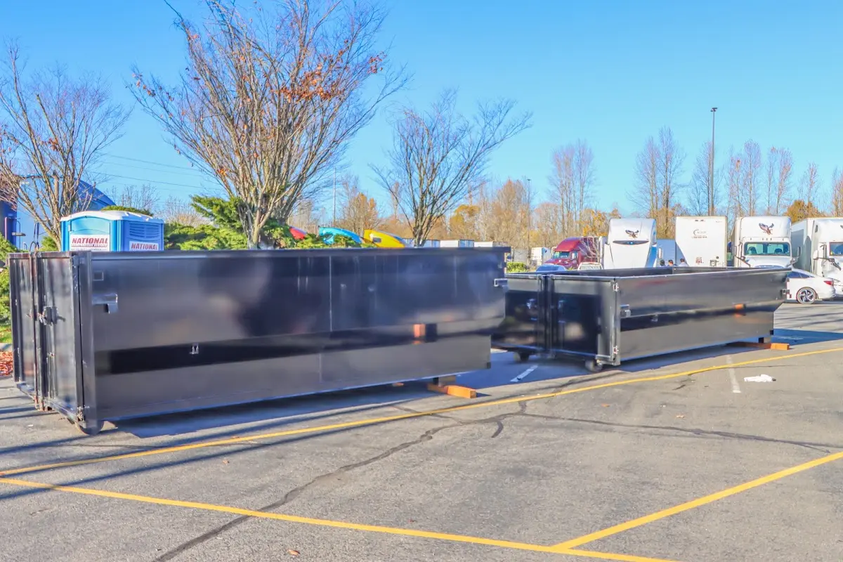 Professional dumpster rental service with roll-off container on residential driveway in Winter Gardens